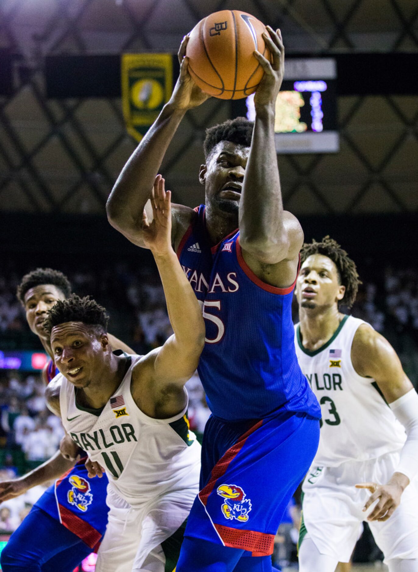 Baylor Bears guard Mark Vital (11) and Kansas Jayhawks center Udoka Azubuike (35) reach for...