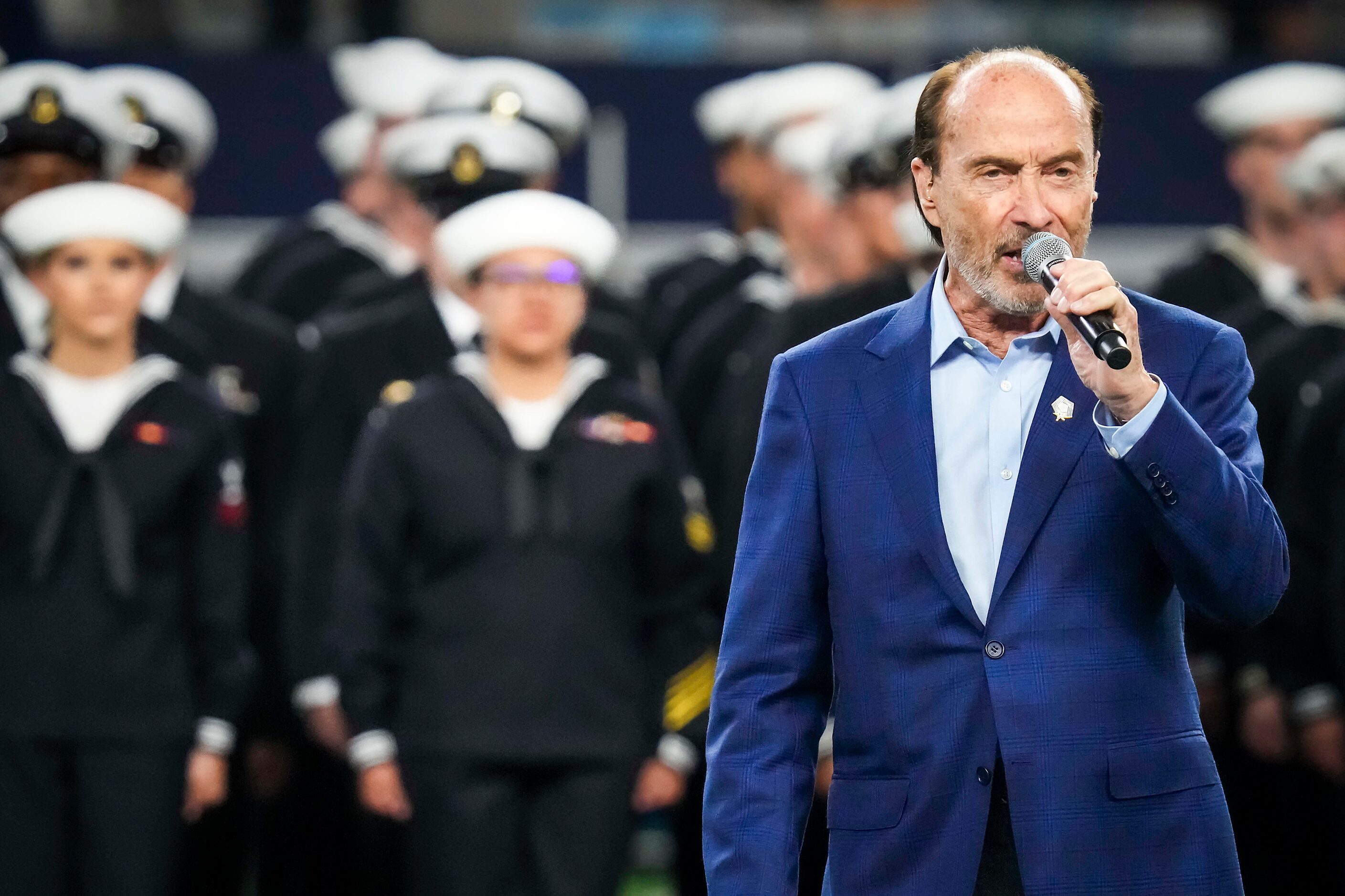 Lee Greenwood sings “Proud to be an American” during halftime of an NFL football game...