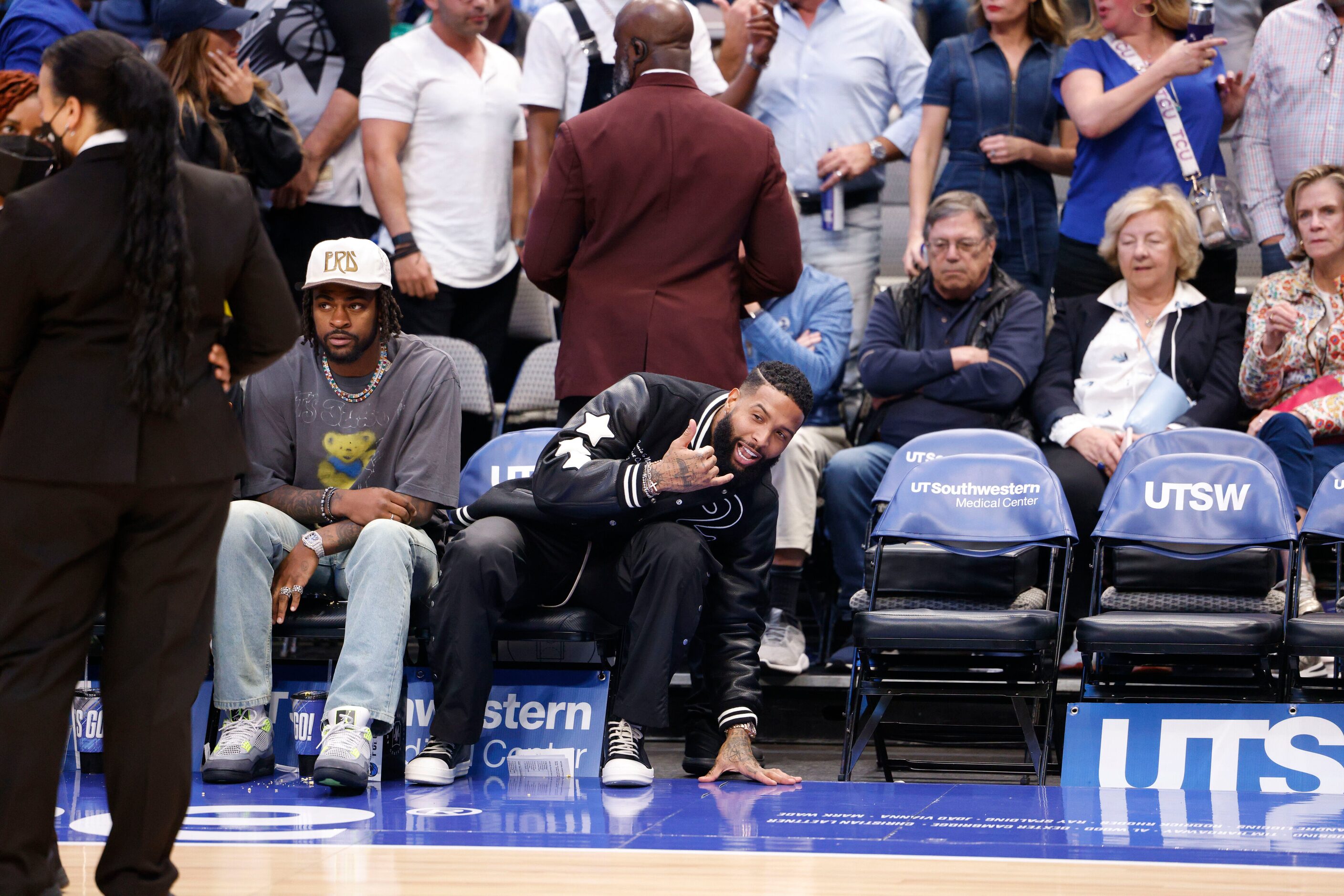 NFL free agent Odell Beckham Jr. (center) talks to people alongside Dallas Cowboys player...