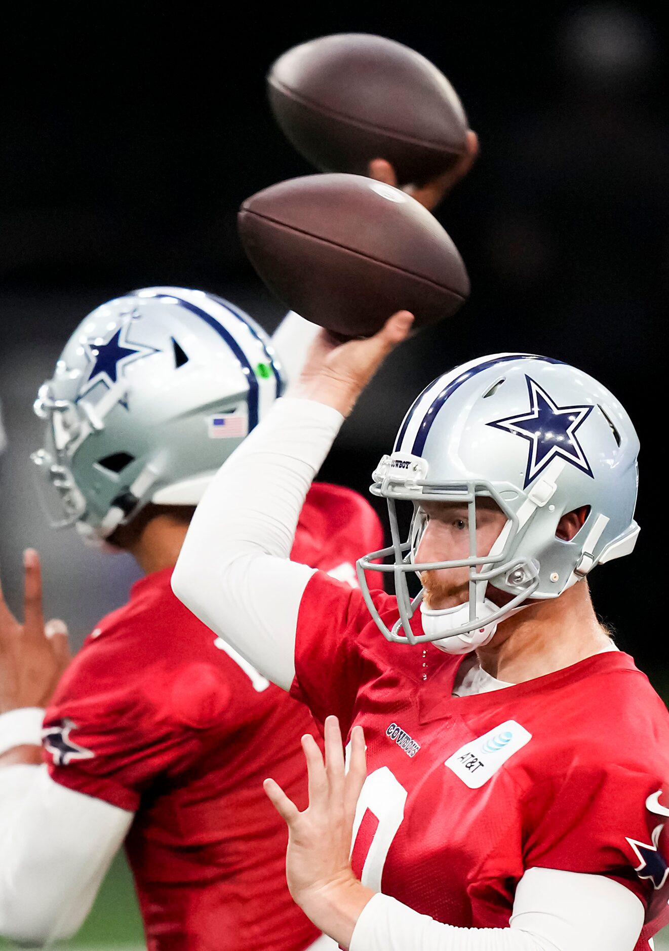 Dallas Cowboys quarterbacks Cooper Rush (front) and quarterback Dak Prescott participate in...