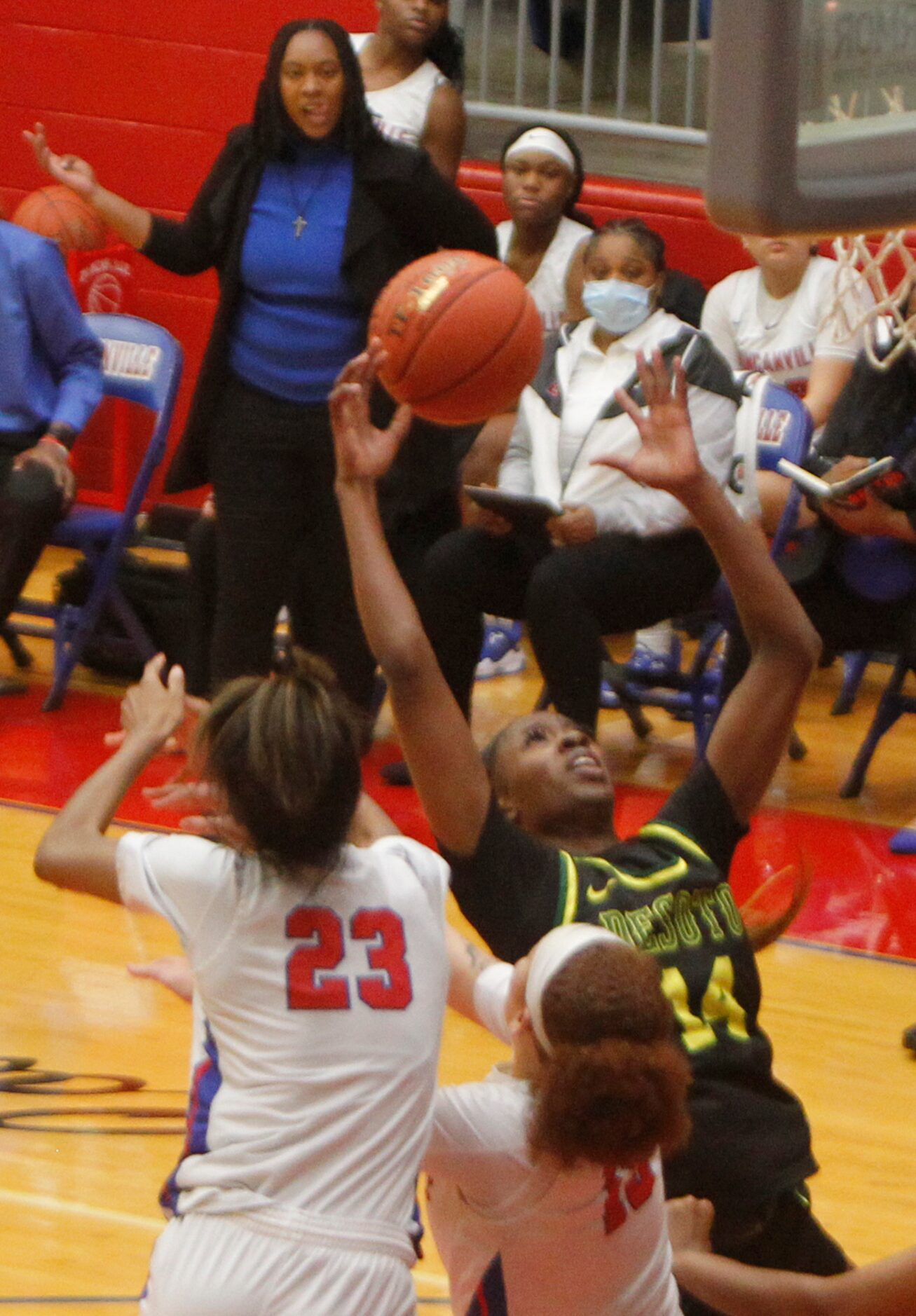 DeSoto's Amina Muhammad (14) reaches for an offensive rebound as she is challenged by...