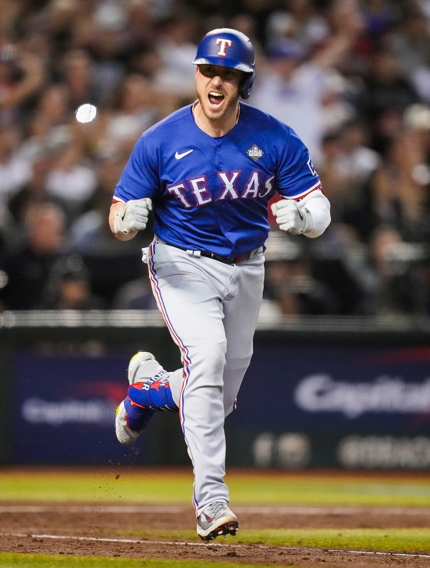 Texas Rangers designated hitter Mitch Garver celebrates a RBI single, scoring Corey Seager,...