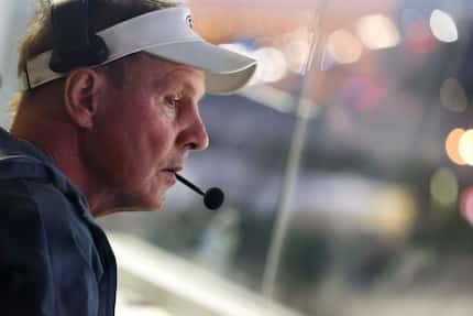 Ennis High School head coach Sam Harrell observes his team from the press box during the...