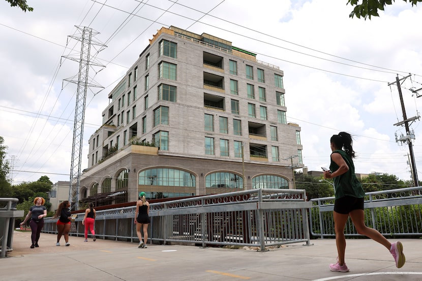 People jog along the Katy Trail with a view of the Terminal at Katy Trail on July 27, 2024,...