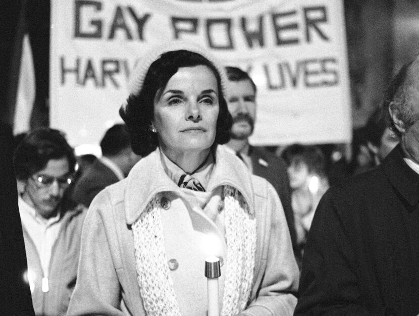 FILE - San Francisco Mayor Dianne Feinstein carries a candle as she leads an estimated...