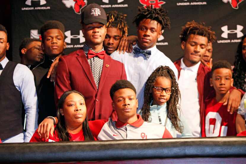 Cedar Hill wide receiver Charleston Rambo sits with friends and family including his mother...