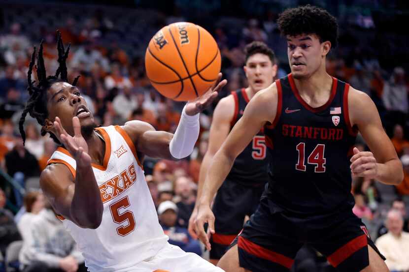 Texas Longhorns guard Marcus Carr (5) tries to save the ball from going out of bounds...