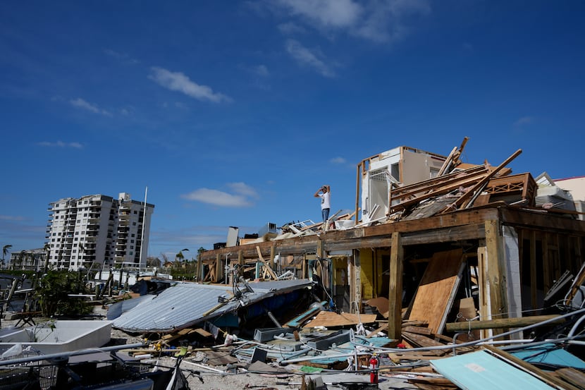 Robert Leisure surveys the wreckage of his business, Getaway Marina, which was destroyed...