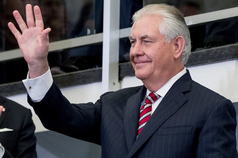 Secretary of State Rex Tillerson waves before speaking to State Department employees upon...