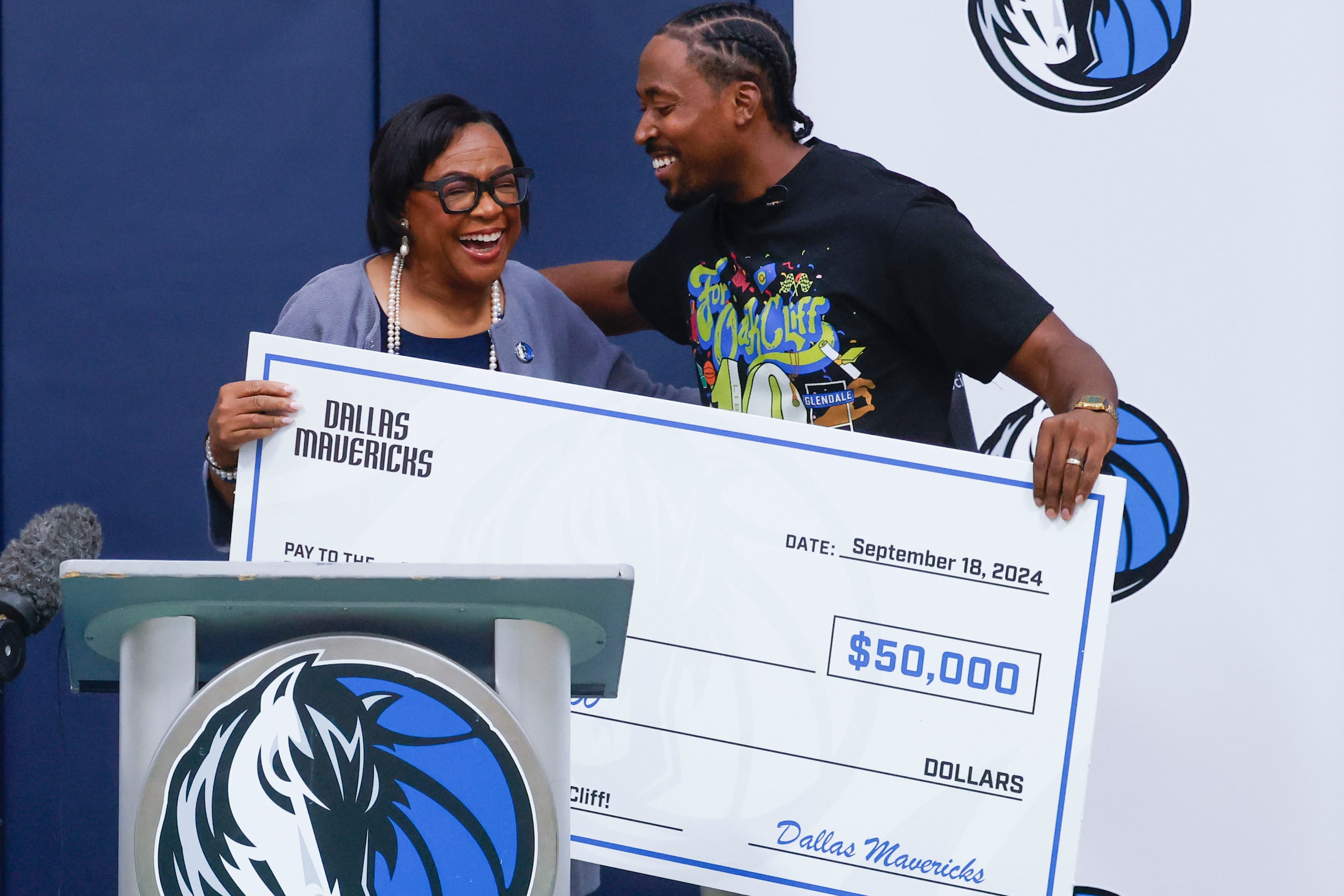 Dallas Mavericks CEO Cynthia Marshall (left) reacts while presenting a donation to Oak Cliff...