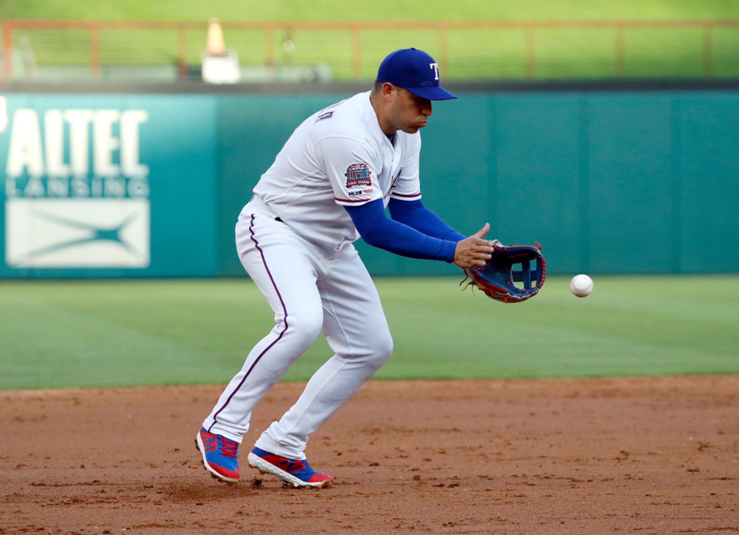 Texas Rangers third baseman Asdrubal Cabrera fields a grounder by Los Angeles Angels'...