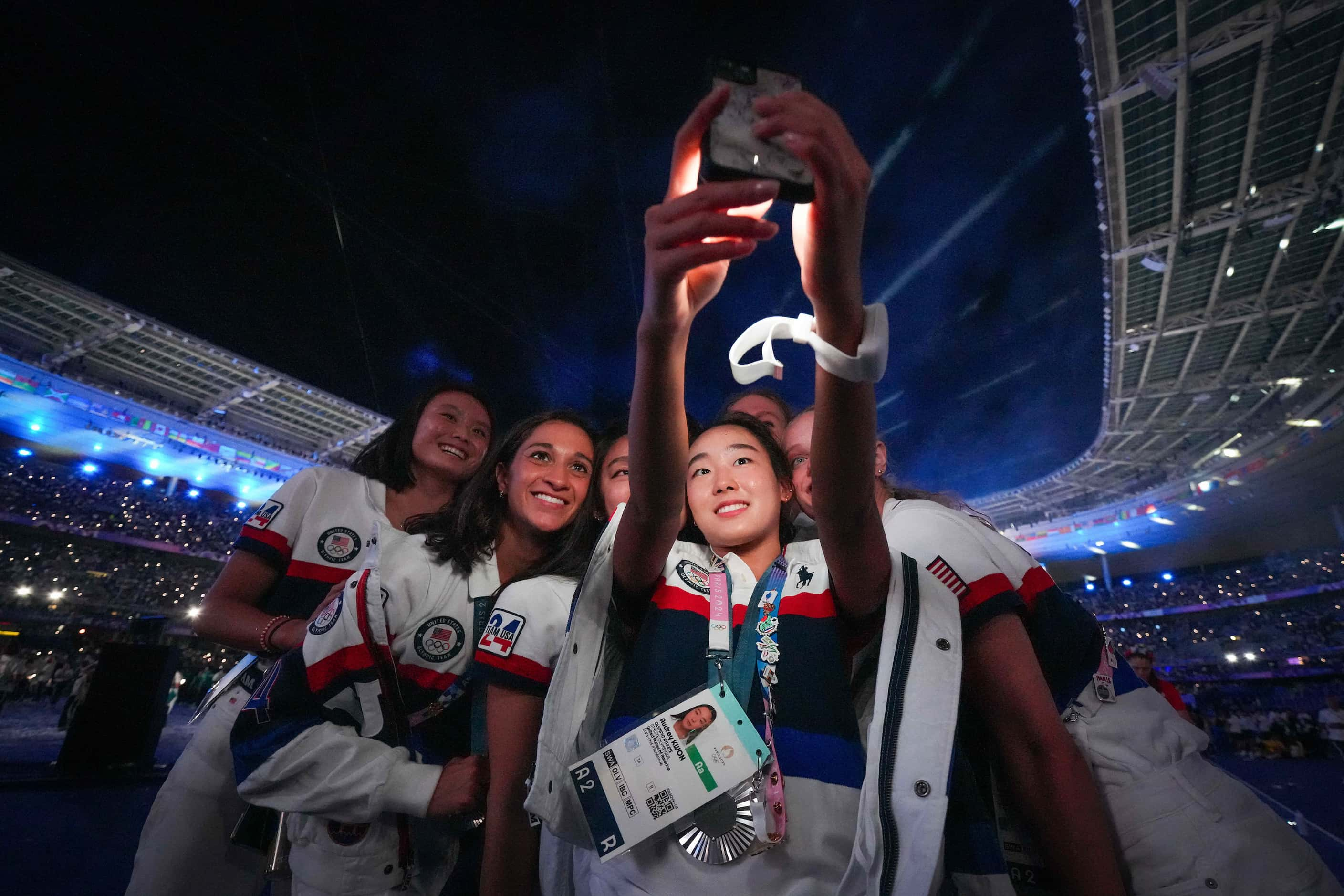 American artistic swimmer takes a selfie with her teammates during closing ceremonies for...