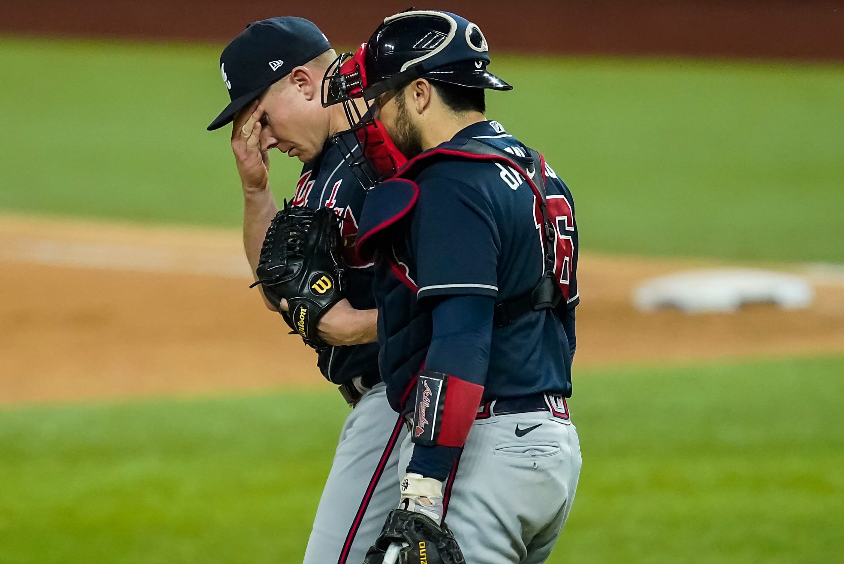 Atlanta Braves relief pitcher Mark Melancon (36) gets a visit fro m catcher Travis d'Arnaud...