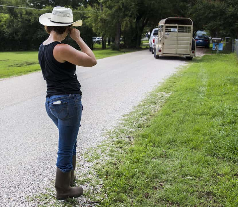 Jess Anselment wipes away a tear as Elizabeth Hendel of Royce City, Texas drives away with...