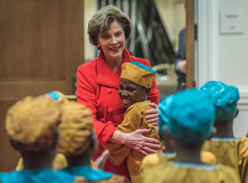 Laura Bush embraced  members of the African Children's Choir before their performance at the...