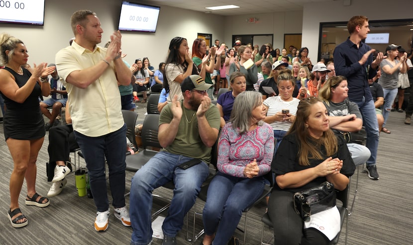 An overflow crowd expressed their support after a speaker addressed the Rockwall ISD School...