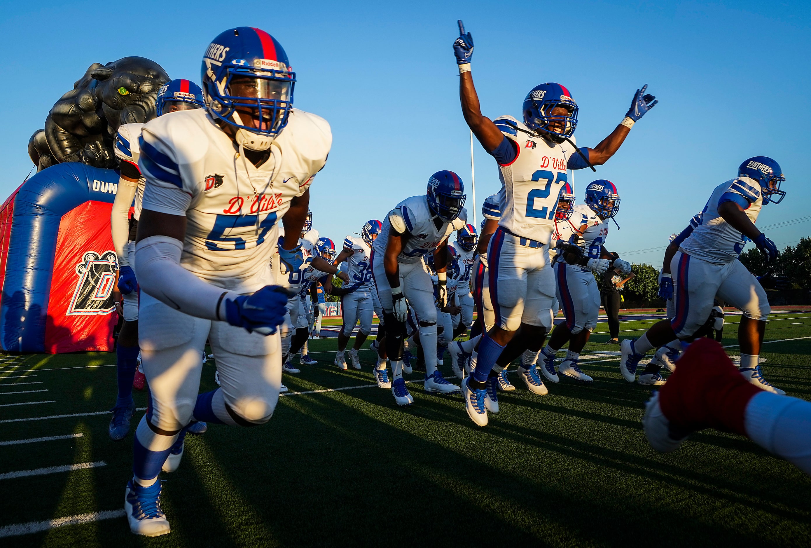 Duncanville players, including defensive lineman Josiah Drake (51) and running back Kaleb...