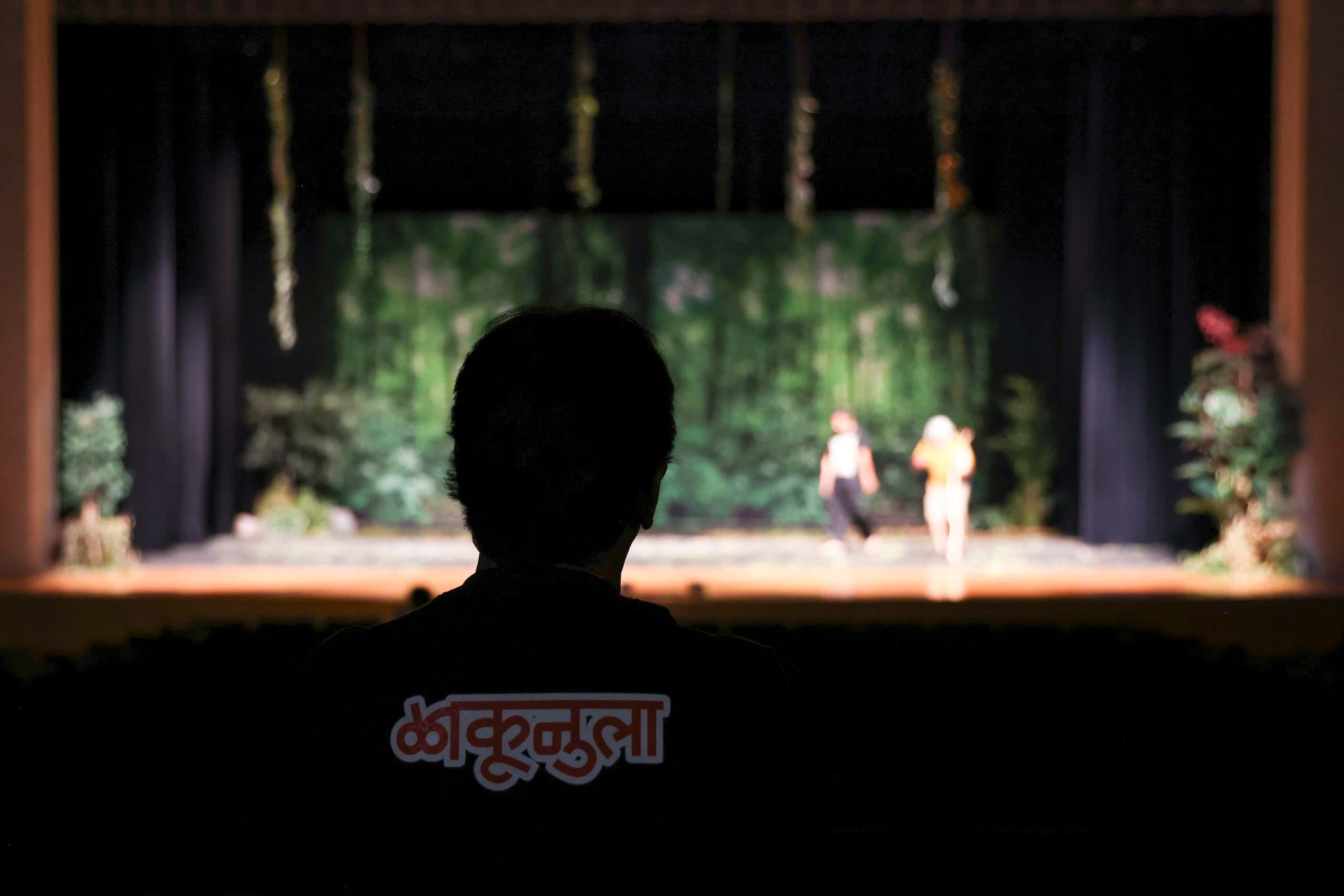 Director and actor Shahiduzzaman Selim, is silhouetted as he takes note of the rehersal of...