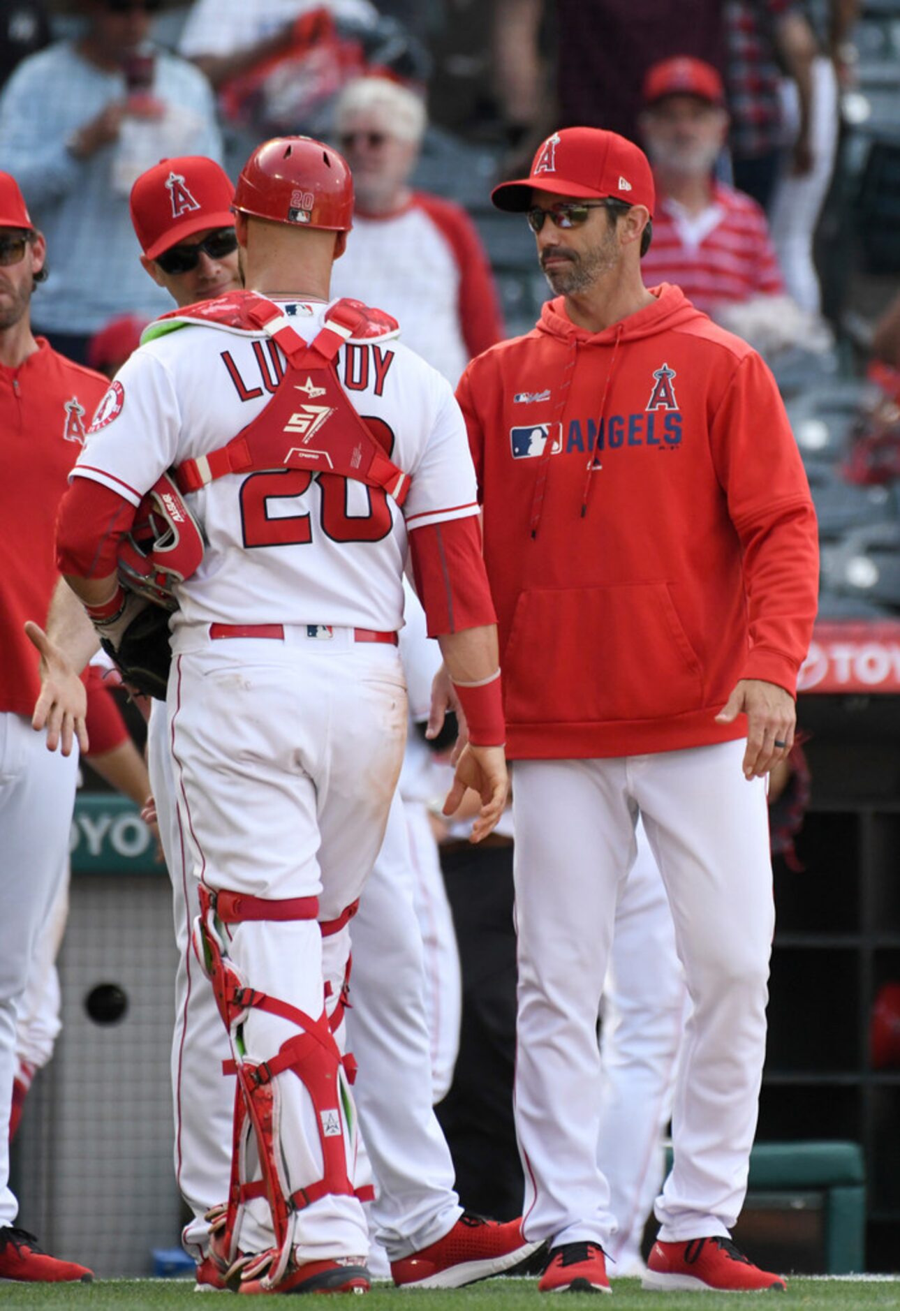 Los Angeles Angels' manager Brad Ausmus, right, congratulates catcher Jonathan Lucroy after...