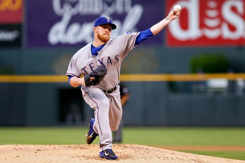 May 6, 2014; Denver, CO, USA; Texas Rangers starting pitcher Robbie Ross (46) pitches in the...