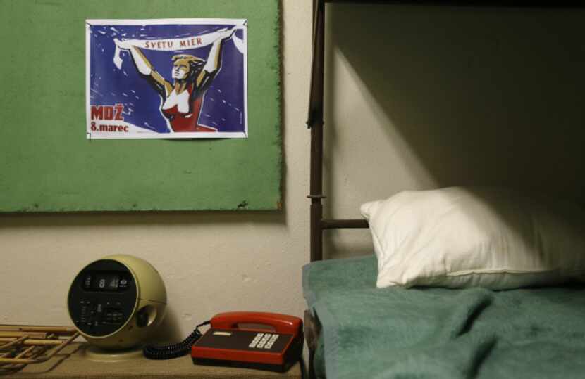 Phone and clock stand next to a bed as part of an installation at the nuclear shelter from...