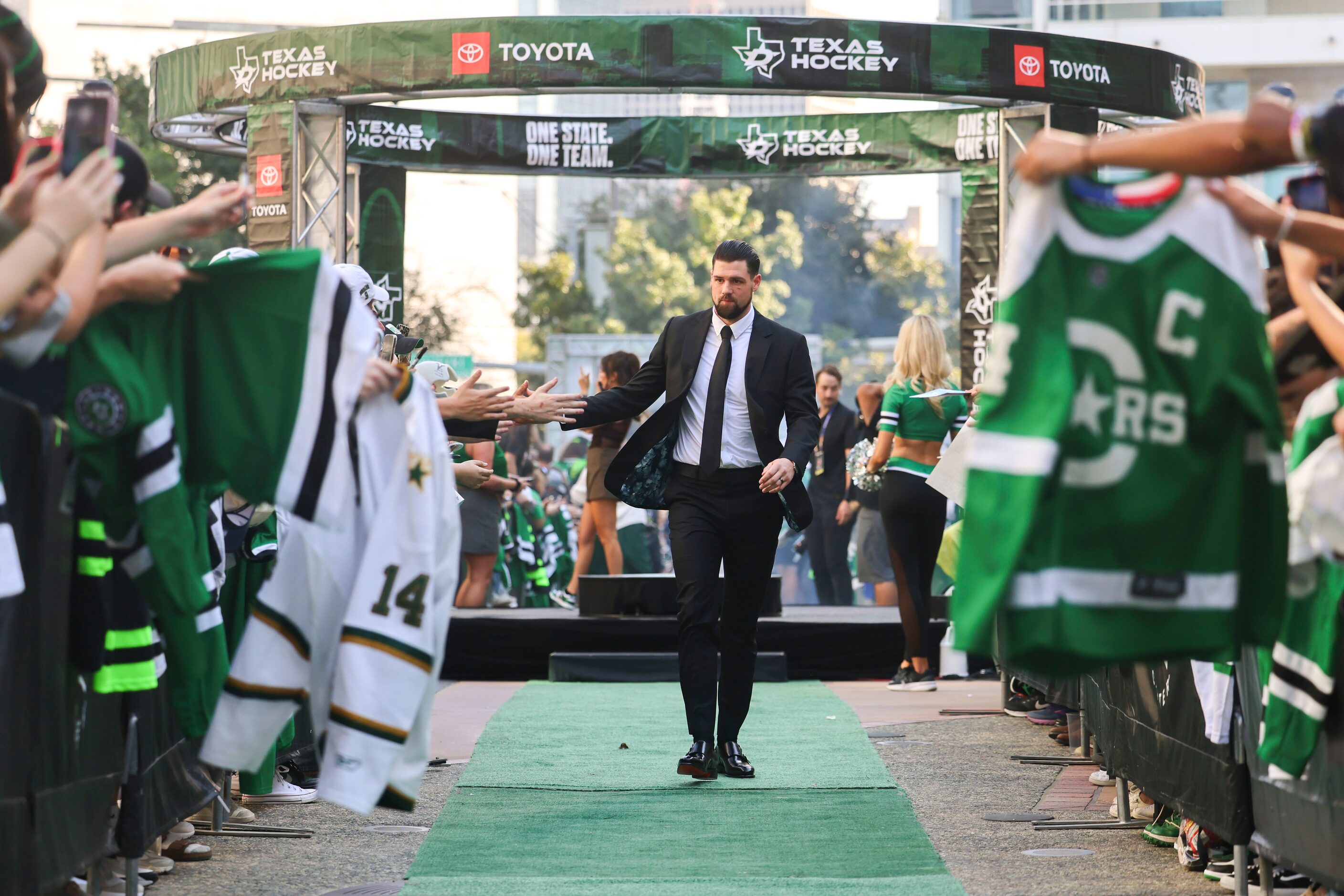 Dallas Stars left wing Jamie Benn high fives fans as he makes his way during the team’s home...