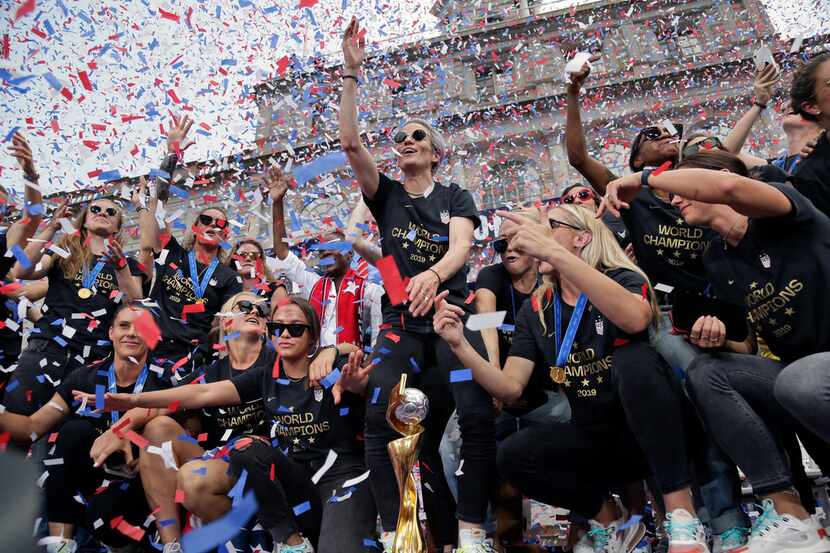The U.S. women's soccer team, with Megan Rapinoe at center, celebrates after a ticker tape...