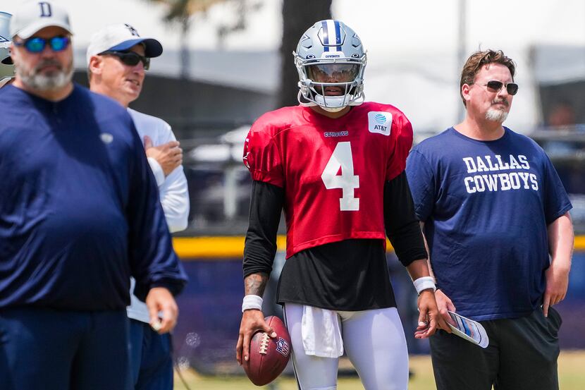 Dallas Cowboys quarterback Dak Prescott (4) watches with, from left head coach Mike...