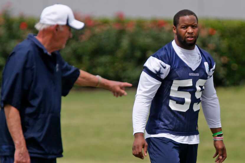 Dallas defensive coach Monte Kiffin instructs linebacker Anthony Hitchens