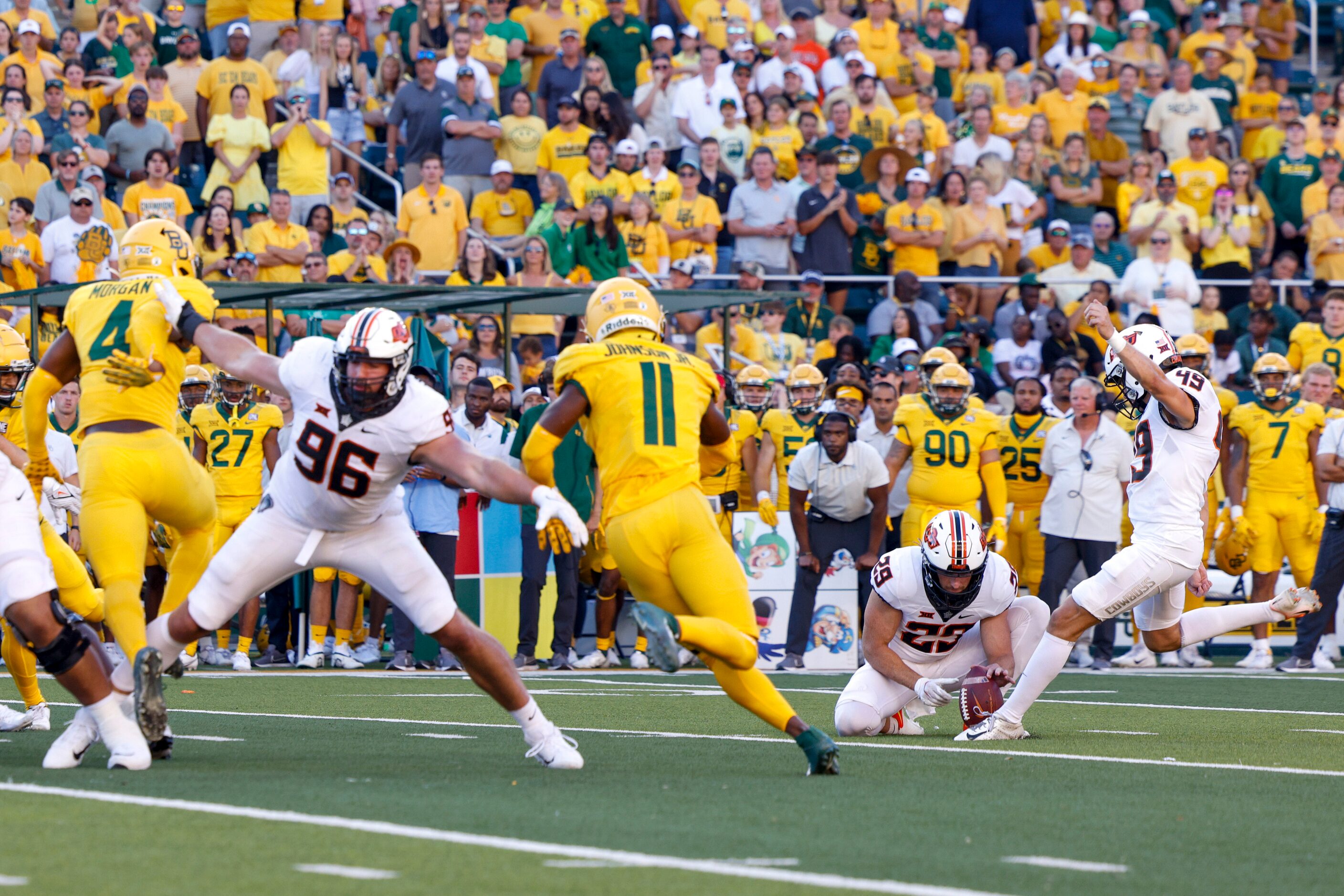 Oklahoma State place kicker Tanner Brown (49) kicks a 19 yard field goal during the second...