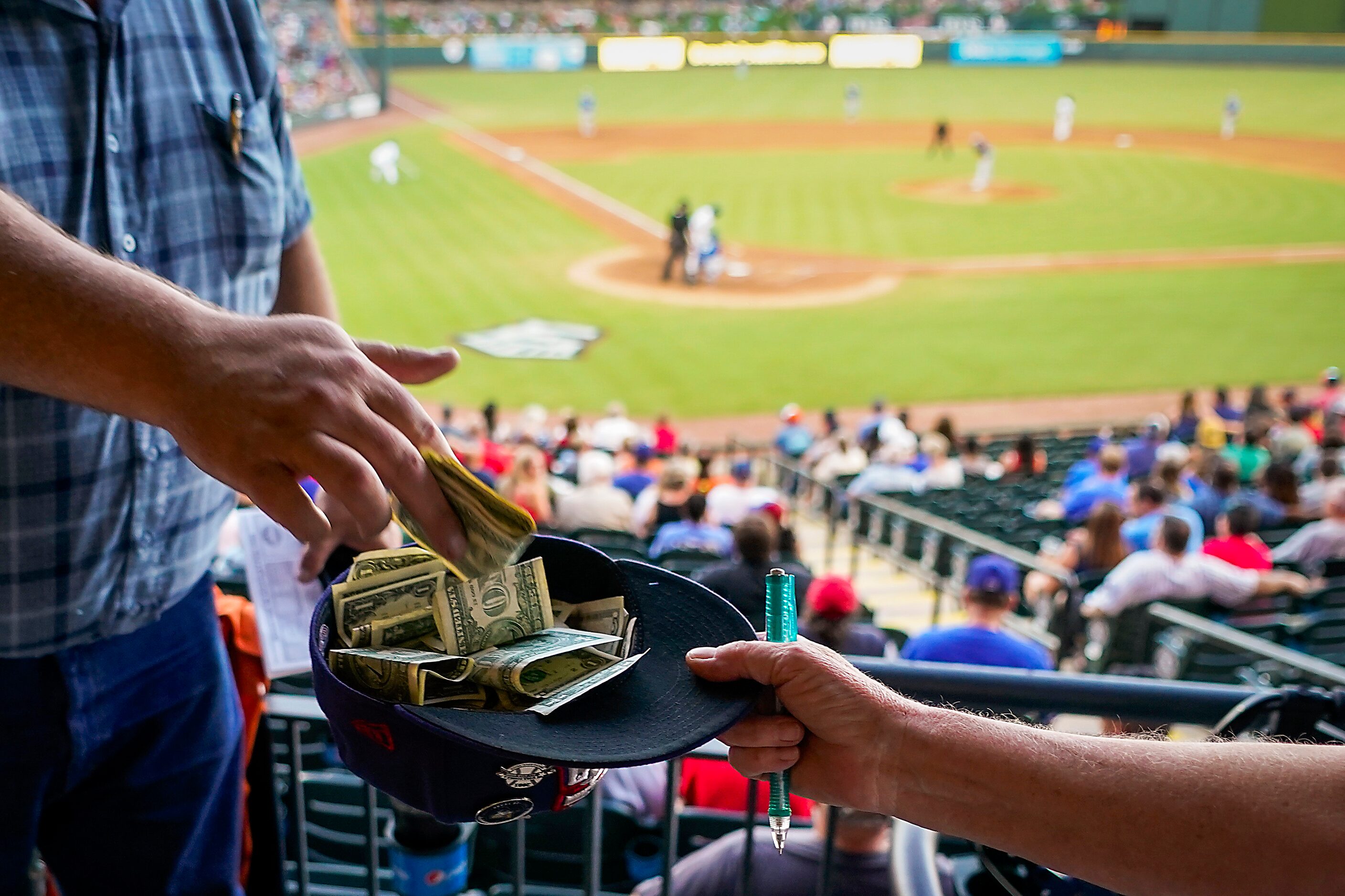 Fans pass the hat after a 2-run home run by Round Rock Express infielder Charles Leblanc...