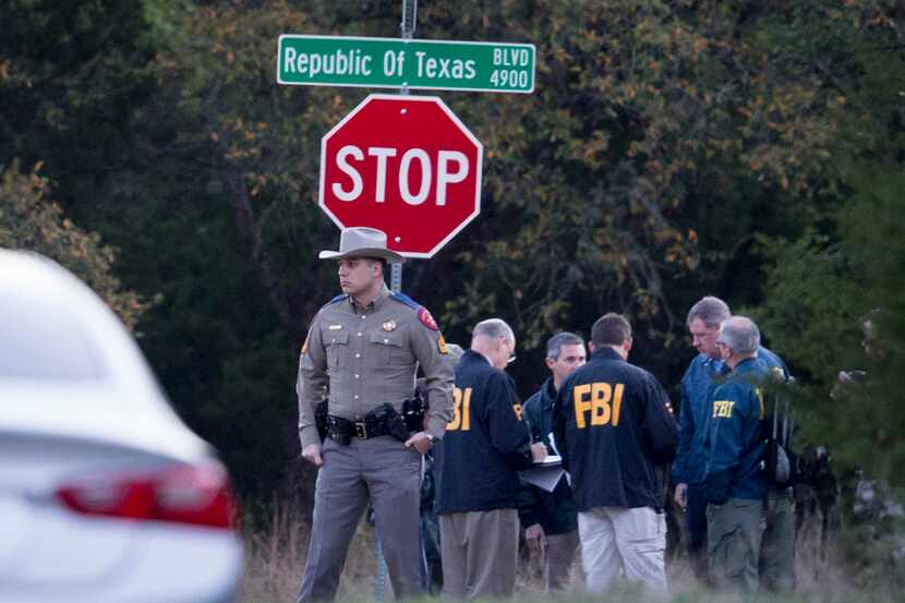 Law enforcement officers gather at the intersection of Republic of Texas and Mission Oaks...