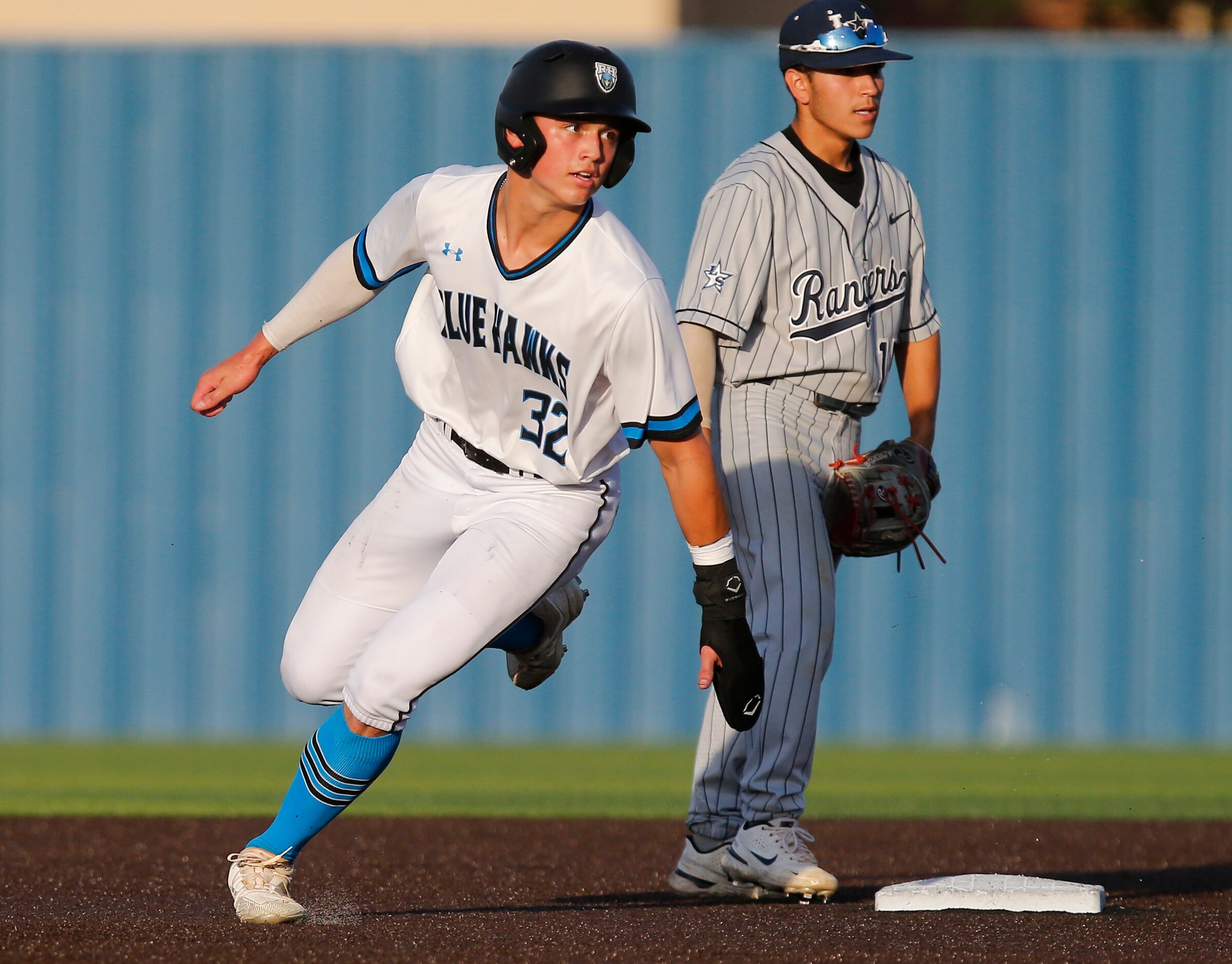 Rock Hill High School center fielder Brenner Cox (32) rounds second base in the first inning...