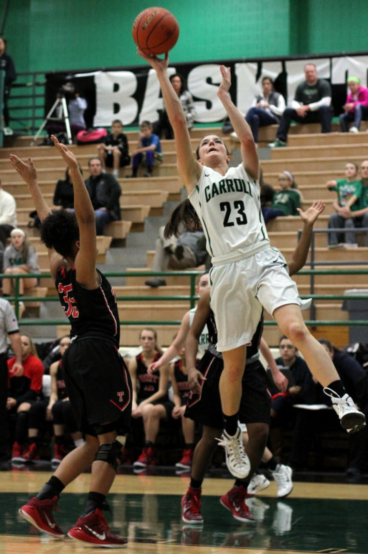 Southlake Carroll forward Priscilla Smeenge (23) scores two of her first half points as...