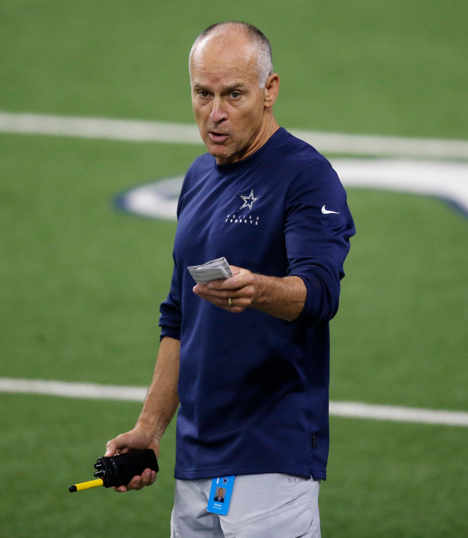 Dallas Cowboys defensive coordinator Mike Nolan talks to players in between plays during...