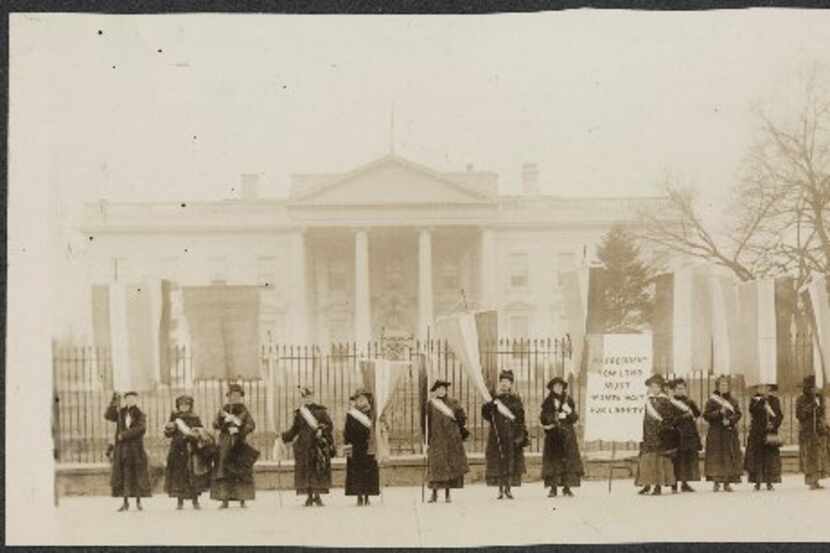 Suffragists are pictured picketing in front of the White House in 1917. 