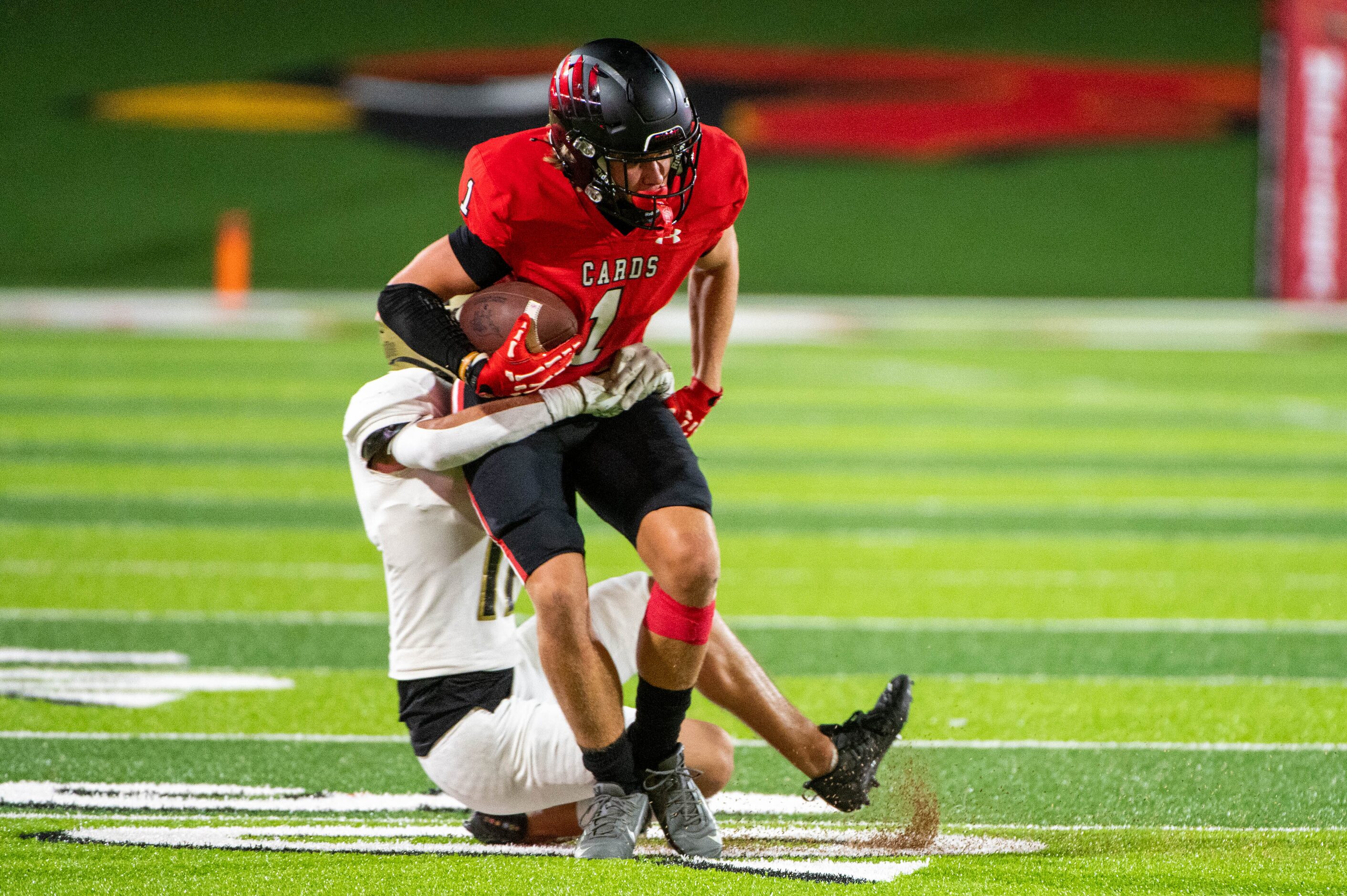 Melissa's wide receiver Lincoln Dunn (1) tries to run through a tackle attempt by Royse City...