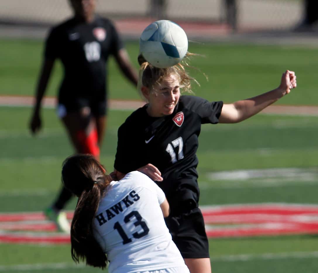 Colleyville heritage forward Allie Love (17) heads the ball away from Pflugerville...