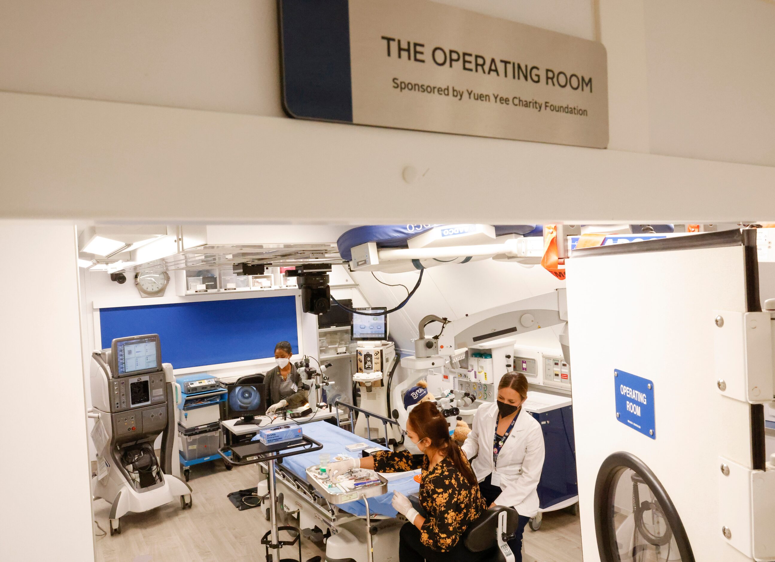 Orbis Flying Eye Hospital resident Dr. Kimberly Hastings of Jamaica, back, instructor Dr....