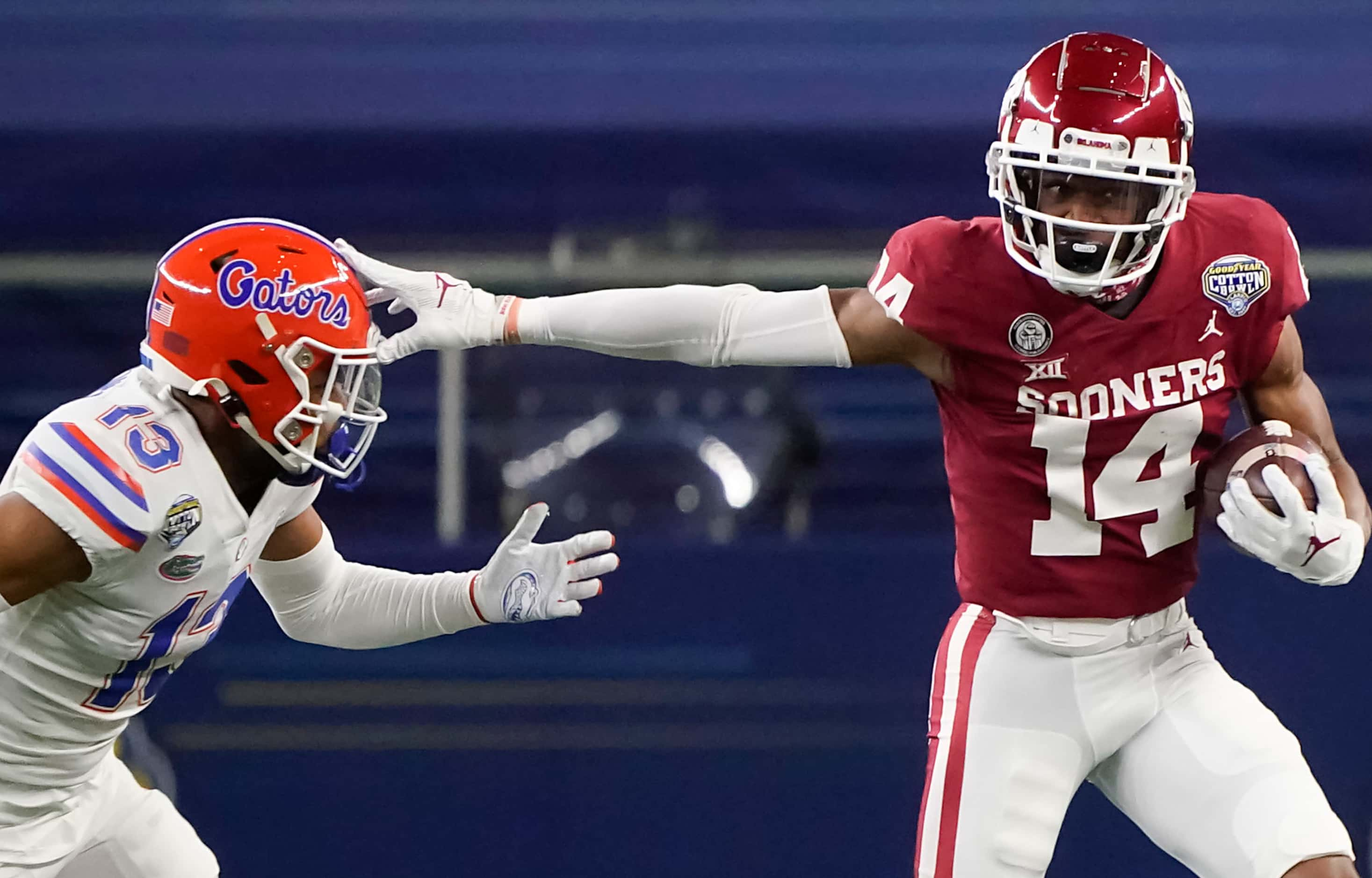 Oklahoma wide receiver Charleston Rambo (14) pushes past Florida defensive back Donovan...