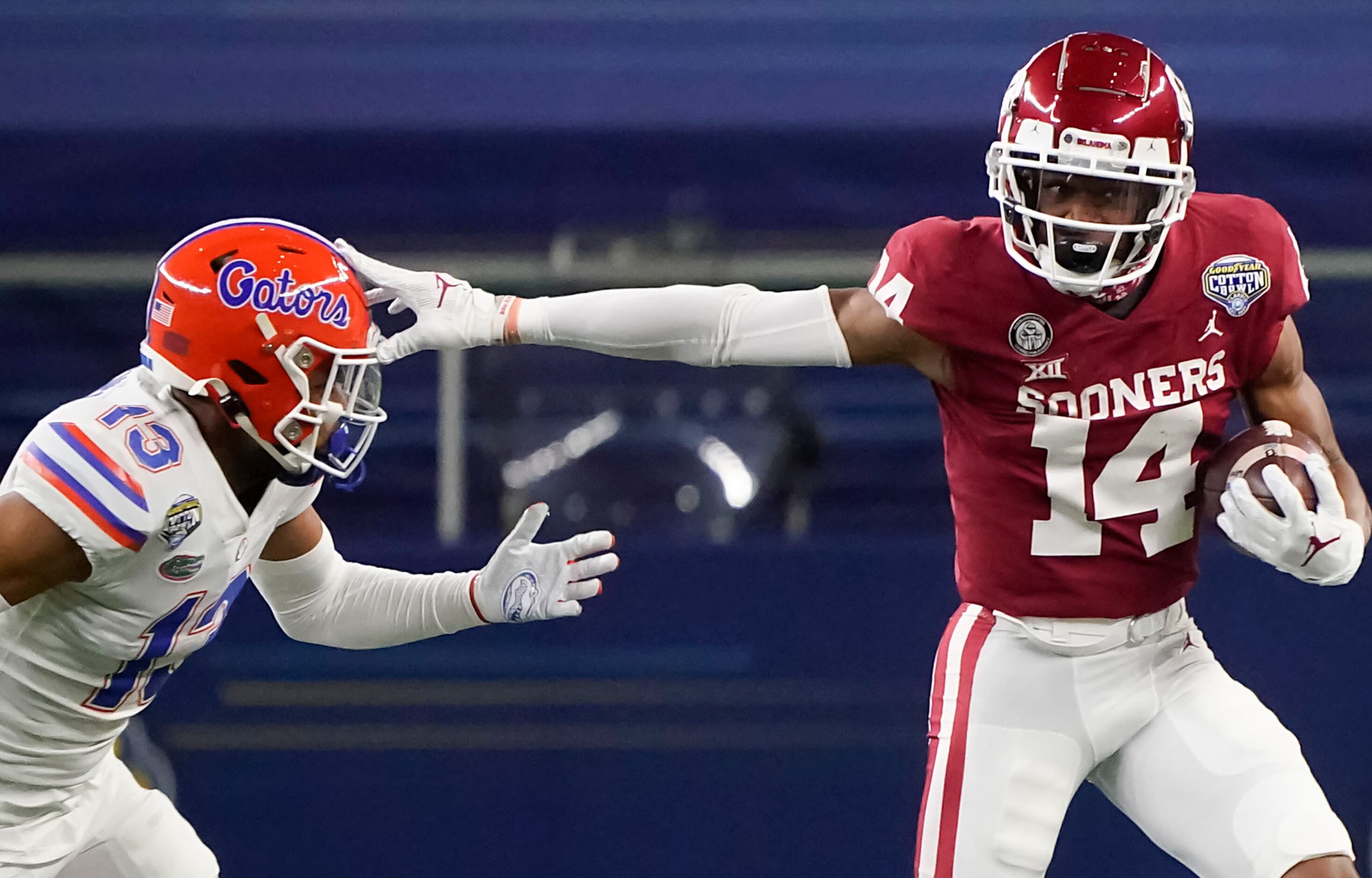 Oklahoma wide receiver Charleston Rambo (14) pushes past Florida defensive back Donovan...