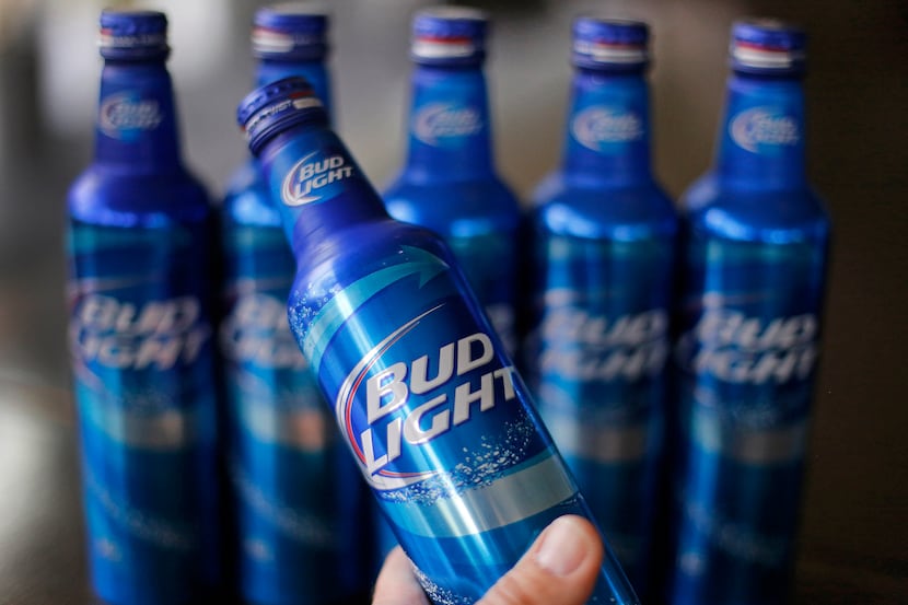 FILE - In this Monday, April 7, 2014, file photo, aluminum bottles of Bud Light beer are on...