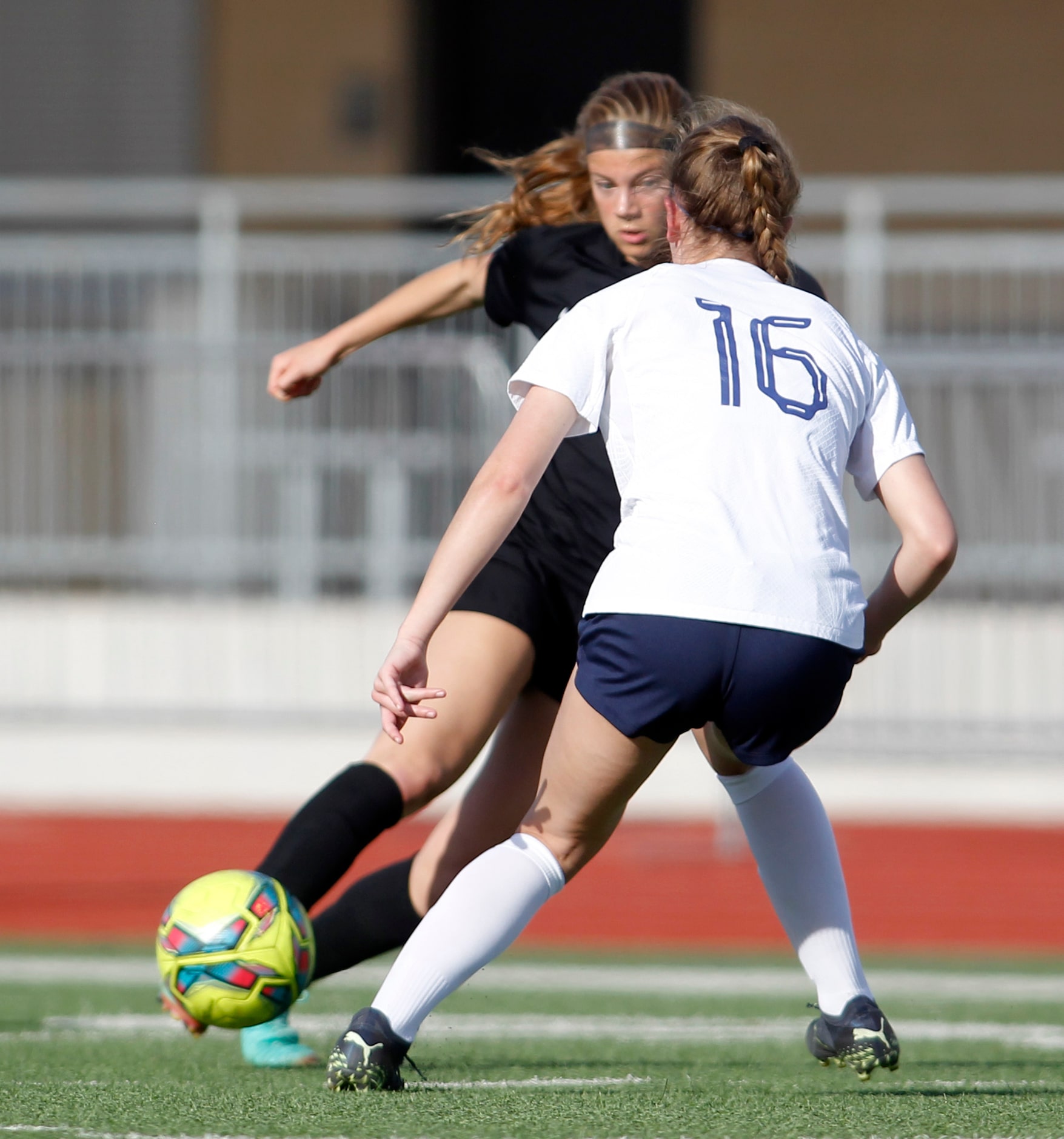 Flower Mound Marcus forward Madi Patterson (17) moves offensively against the defense of...