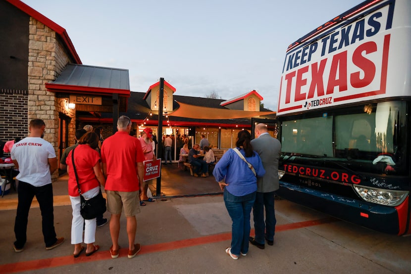 People bow their heads in prayer at the start of a campaign rally for U.S. Sen. Ted Cruz,...