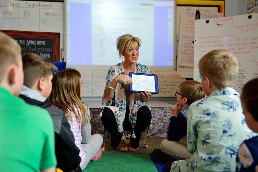 Third-grade teacher Kayla Delzer explains a math exercise on the program Seesaw to her...