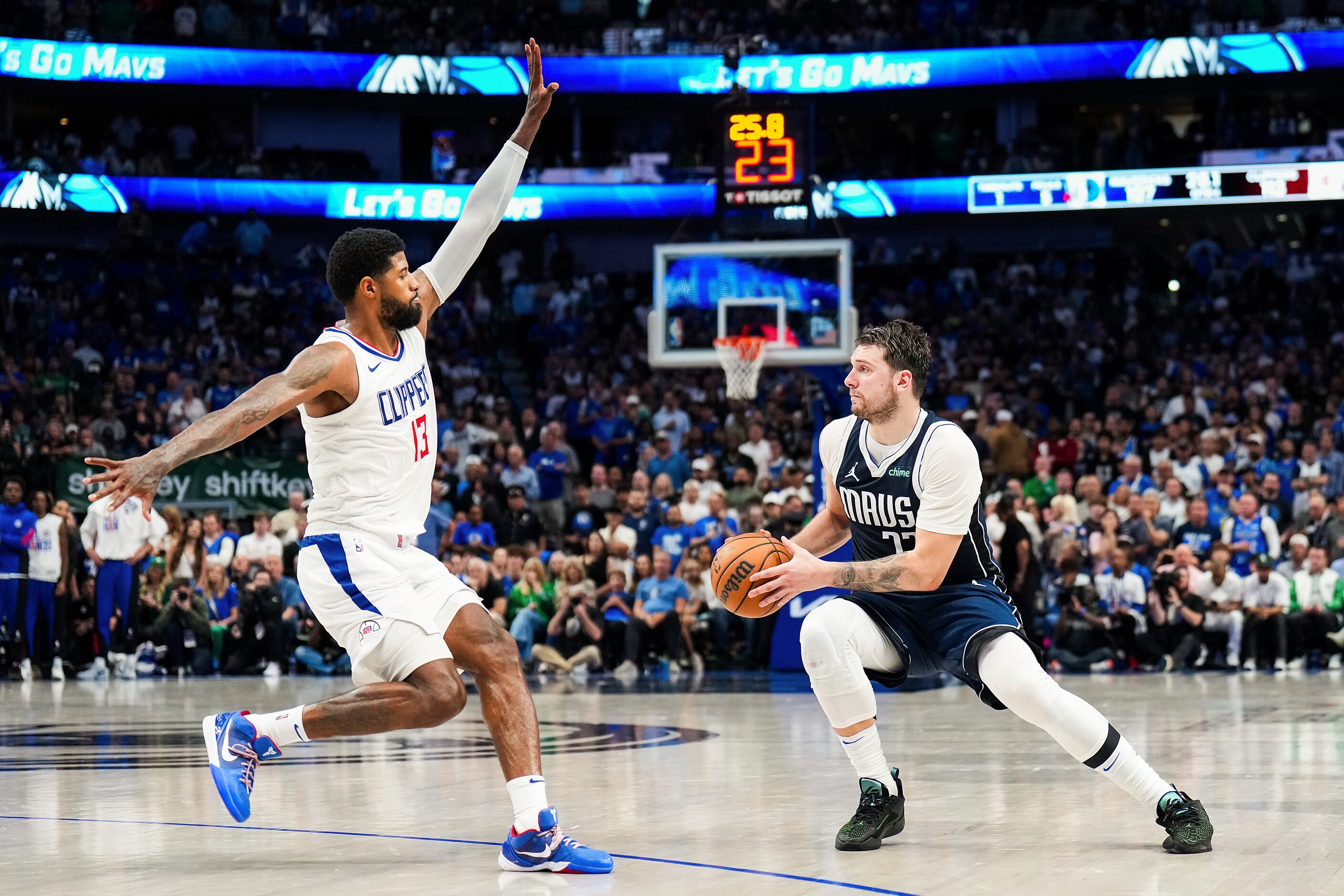 Dallas Mavericks guard Luka Doncic (77) drives around LA Clippers forward Paul George (13)...