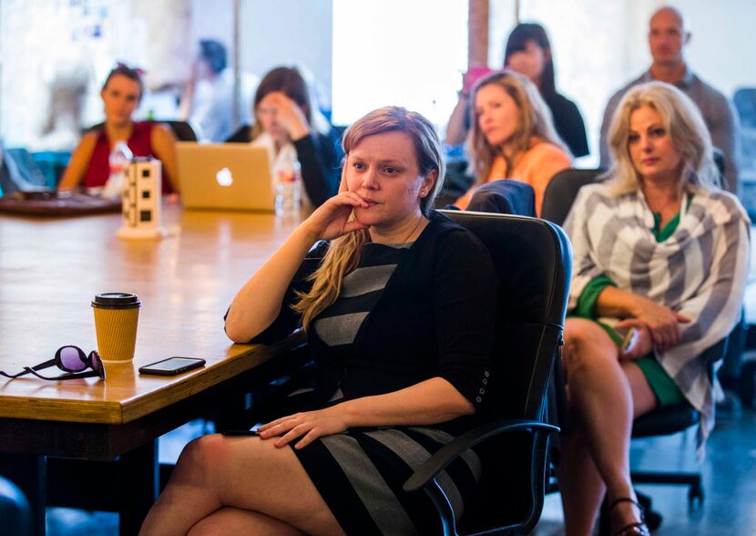 Darlene Schneider (center) and other participants listen to a session called "Travel: Travel...