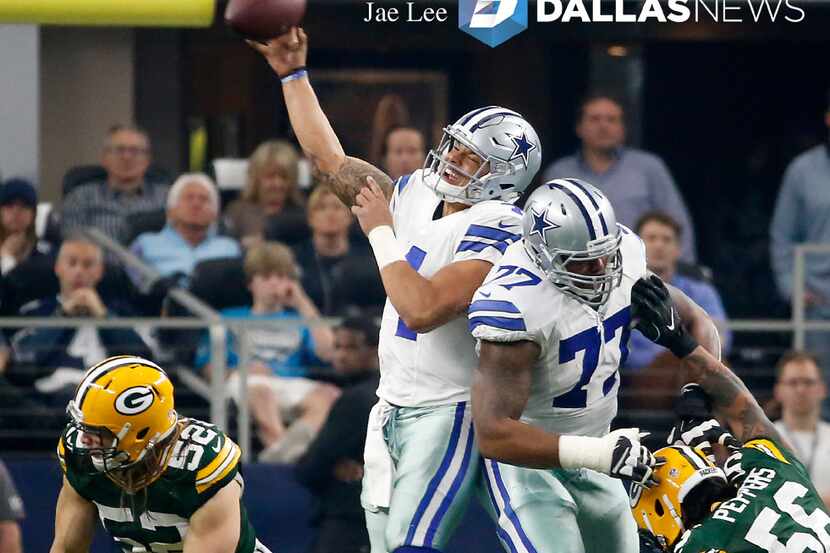 Dallas Cowboys quarterback Dak Prescott (4) throws the ball as he's hit by tackle Tyron...