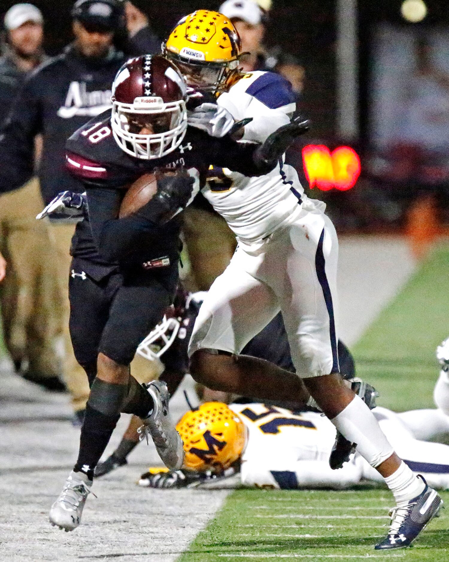 Wylie High School wide receiver Malik Ford (18) is forced out of bounds by McKinney High...