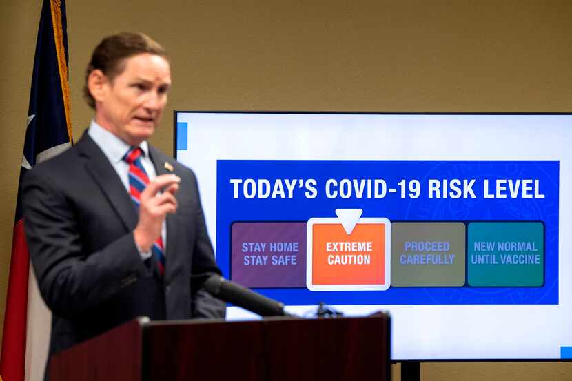 Dallas County Judge Clay Jenkins announces a shift from red to orange in the COVID-19 risk...